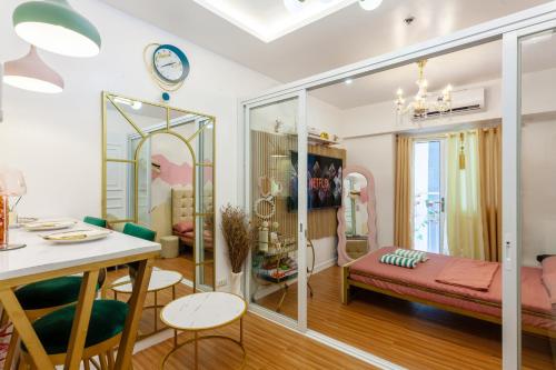 a living room with a room with glass walls at Unique Chiq and comfy place with board games, Quezon City in Manila