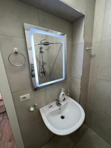 a bathroom with a sink and a mirror at Fila Apartments in Tirana