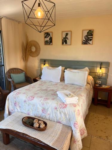 a bedroom with a bed with a bowl on a table at Los Pecados de la Viuda in Punta Del Diablo