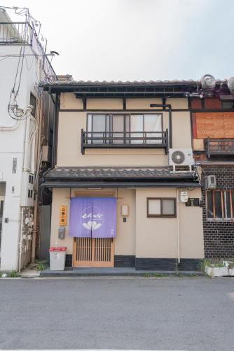 a building with a purple sign on the front of it at Shirakabanoyado - MUTSUKI, Japanese House with Garden & 3 Bathrooms, 白樺の宿 睦月 in Osaka