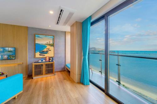 a room with a large window with a view of the ocean at Sala Quy Nhon Beach Hotel in Quy Nhon