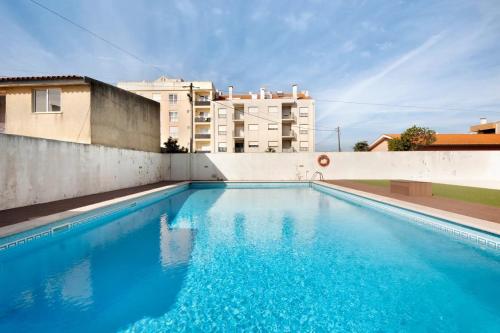 a swimming pool on the side of a building at Live Vagueira Beach in Praia da Vagueira