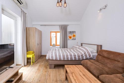 a living room with a bed and a couch at Yvonne in Krk