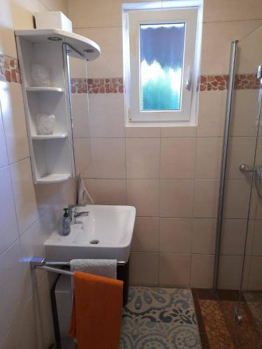 a bathroom with a sink and a window at Ferienwohnung Weber in Schleiden