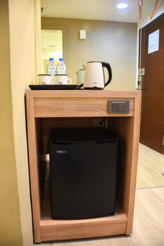 a kitchen counter with a coffee maker on top of it at Yoyo Hotel in Chiayi City