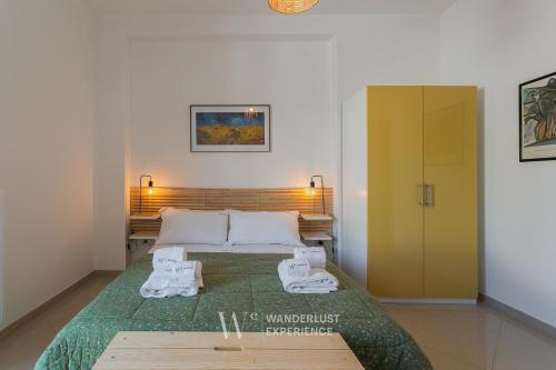 a bedroom with a bed with two towels on it at Wanderlust Experience La Casetta in Bitonto