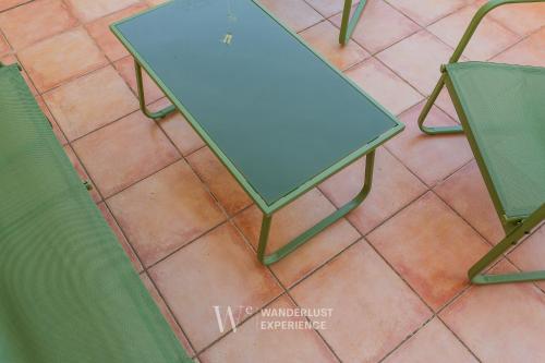 a blue table and two chairs on a tile floor at Wanderlust Experience La Casetta in Bitonto