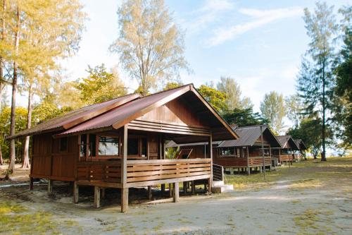 a group of wooden huts in a forest at Andau Dive Resort Raja Ampat in Tapokreng