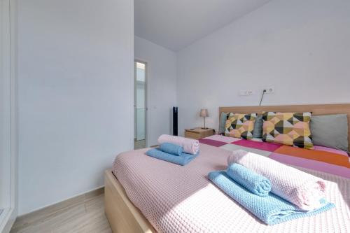 una camera da letto con un letto con cuscini blu di Casa Dang - 600M to the Beach a Costa Teguise