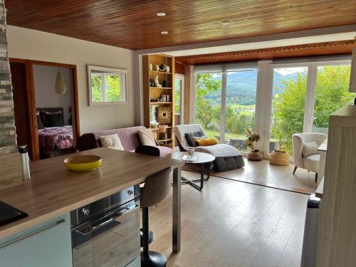 a kitchen and living room with a large window at Chalet cosy dominant le village in Lus-la-Croix-Haute