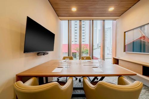a conference room with a large wooden table and chairs at The Westin Sao Paulo in Sao Paulo
