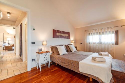 a bedroom with a large bed and a bathroom at Domus Ghirada Terrace in Treviso