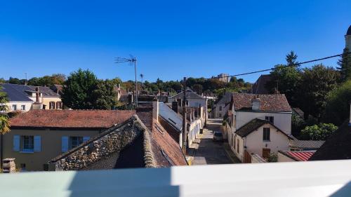 a view of a town from the roof of a building at Appartement cosy et calme, vue sur le château in Nogent-le-Rotrou