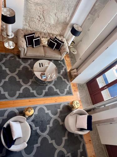 an overhead view of a living room with a couch and chairs at Oporto Golden Apartment in Porto