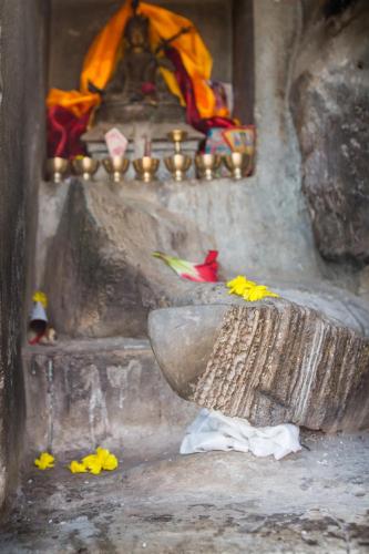 a temple with a large bowl with flowers on it at Everest Home Stay Temal Kalimati Tower in Thapathali