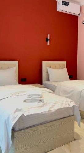 two beds sitting next to each other in a room at Хотел Пандора in Muruntau
