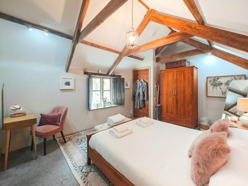 a bedroom with two beds and a desk and a chair at 1 Bed in Newquay oc-c33290 in Saint Columb Major