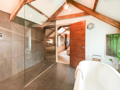 a bathroom with a glass shower and a tub at 1 Bed in Newquay oc-c33290 in Saint Columb Major