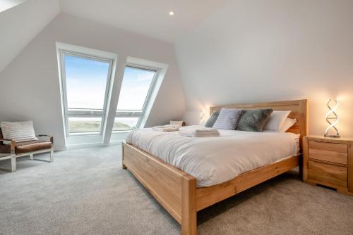 a bedroom with a large bed and two windows at 2 Bed in Tintagel oc-g33170 in Tintagel