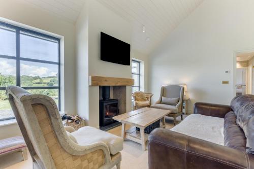 a living room with a couch and a fireplace at 4 Bed in Halfway oc-t33077 in Llandovery