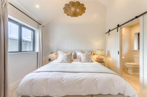 a bedroom with a large white bed and a window at 4 Bed in Halfway oc-t33077 in Llandovery