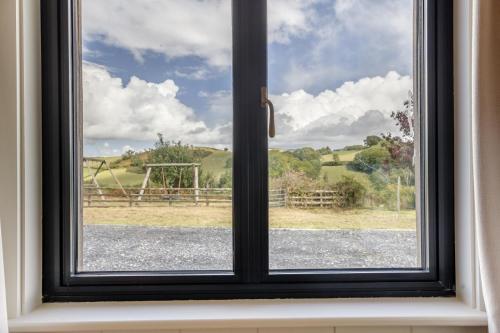a window with a view of a field at 4 Bed in Halfway oc-t33077 in Llandovery