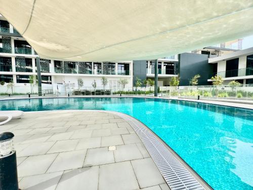 an indoor swimming pool in a building with a building at Modern 2BR Retreat at The Gate in Masdar City in Abu Dhabi