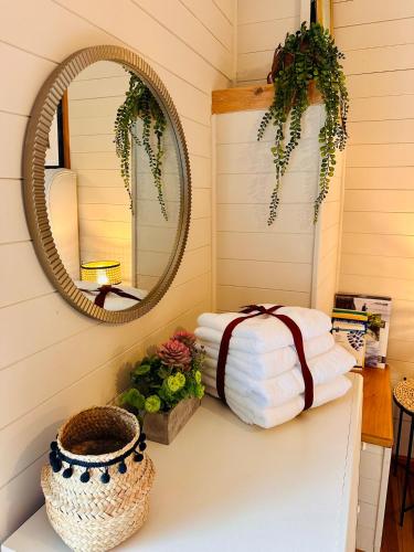 a stack of towels on a counter with a mirror at The annex on our farm in Colwyn Bay
