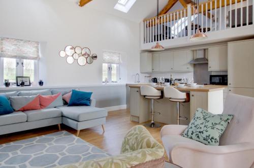 a living room with a couch and a kitchen at The Turnip House in Edgefield