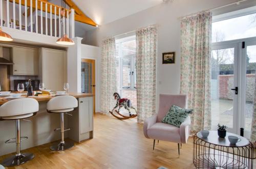a kitchen and living room with a dog in the background at The Turnip House in Edgefield