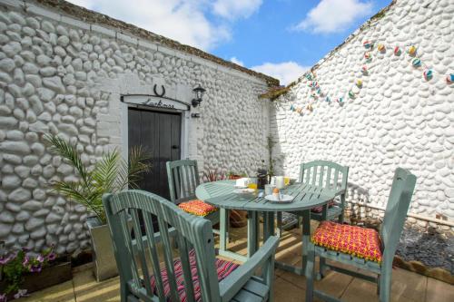 a patio with a table and chairs and a building at Larkrise in West Runton