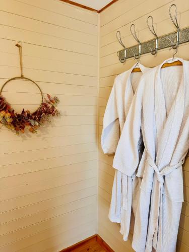 a bathroom with white towels hanging on a rack at The annex on our farm in Colwyn Bay