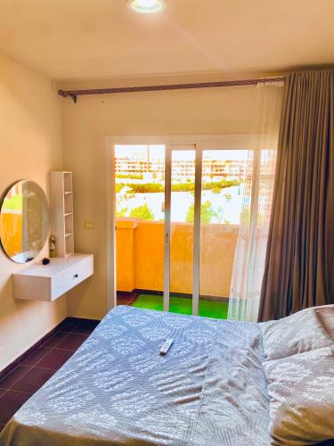 a bedroom with a bed and a window at Porto Sharm Family Chalet with Pool View in Sharm El Sheikh
