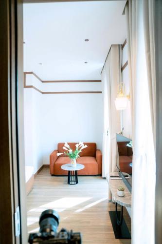 a living room with a couch and a table at Toàn Cầu Hotel Quảng Bình in Dong Hoi