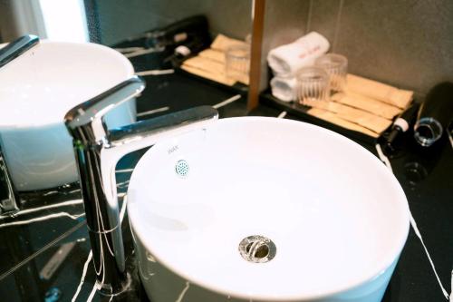 a bathroom with a white sink and a mirror at Toàn Cầu Hotel Quảng Bình in Dong Hoi