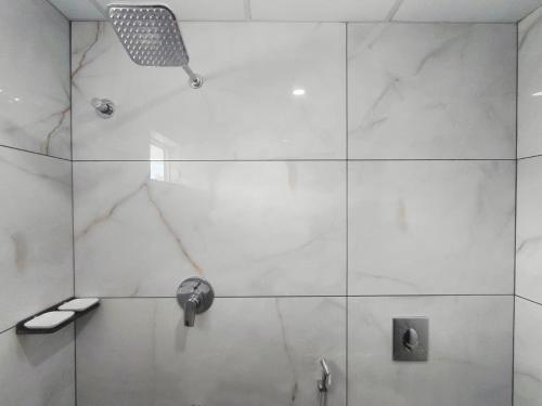 a bathroom with a shower with a shower head at Dalal Residency in Kottakkal