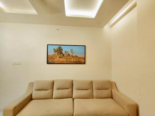 a couch in a room with a painting on the wall at Dalal Residency in Kottakkal
