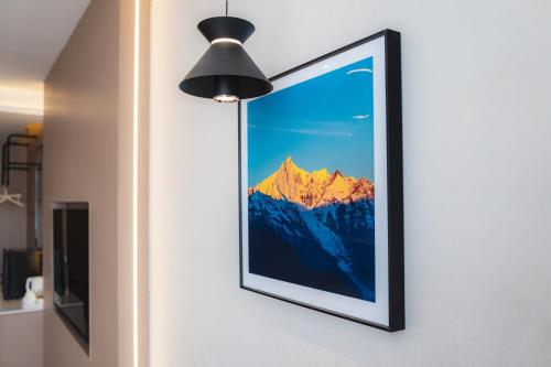 a framed picture of a mountain on a wall at Shangge Boya Hotel in Shangri-La
