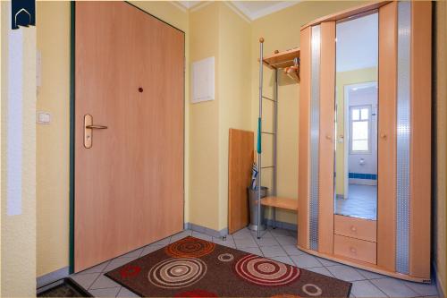 a bathroom with a shower and a door and a rug at Ferienwohnung Koralle in Ostseebad Koserow