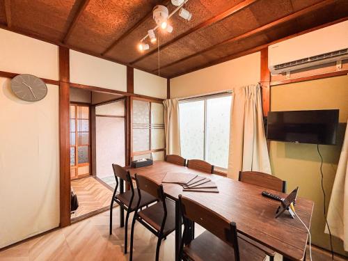 a dining room with a table and a television at BUSHIDO Kinugawa -Nikko-Tochigi in Nikko