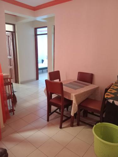 a dining room with a table and chairs at Mtwapa Luxurious Residence with Pool B1M in Mombasa