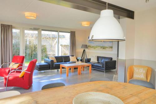 a living room with a table and chairs at Sandy 25 in Callantsoog
