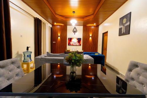 a living room with a table and a couch at Your Kigali Base a 2 Bedroom with Kitchen and Private Parking in Kigali