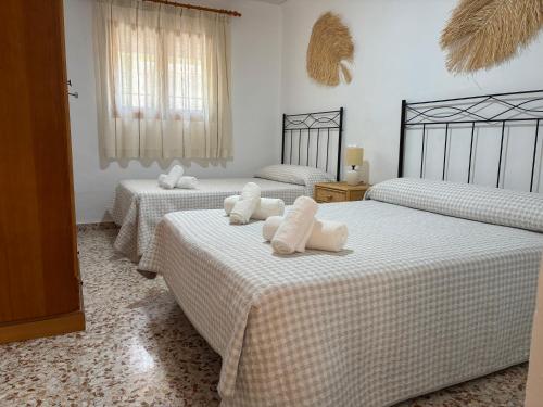 a room with three beds with towels on them at Casa Riondas in Moratalla