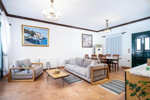 a living room with a couch and a table at Marys Beachfront Villa in Kalymnos