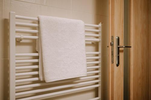 a towel hanging on a towel rack in a bathroom at Villa KESTA, centrum, free parking in Martin