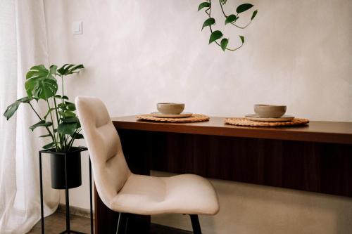 a table with two cups and a chair and a plant at Villa KESTA, centrum, free parking in Martin