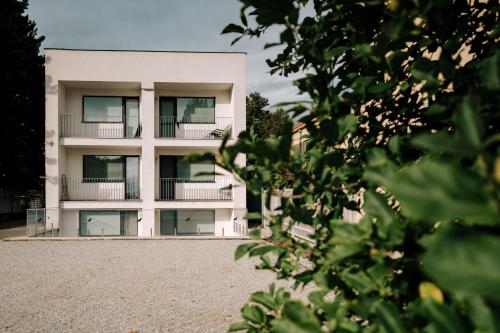 a white building with balconies on the side of it at Villa KESTA, centrum, free parking in Martin