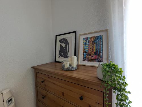 a wooden dresser with two pictures on top of it at Mirador de San Andrés in Calatayud