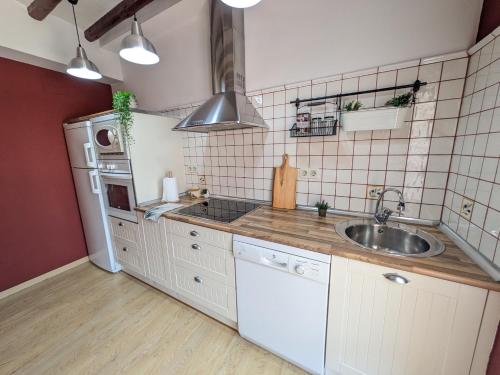 a kitchen with white cabinets and a sink at Mirador de San Andrés in Calatayud